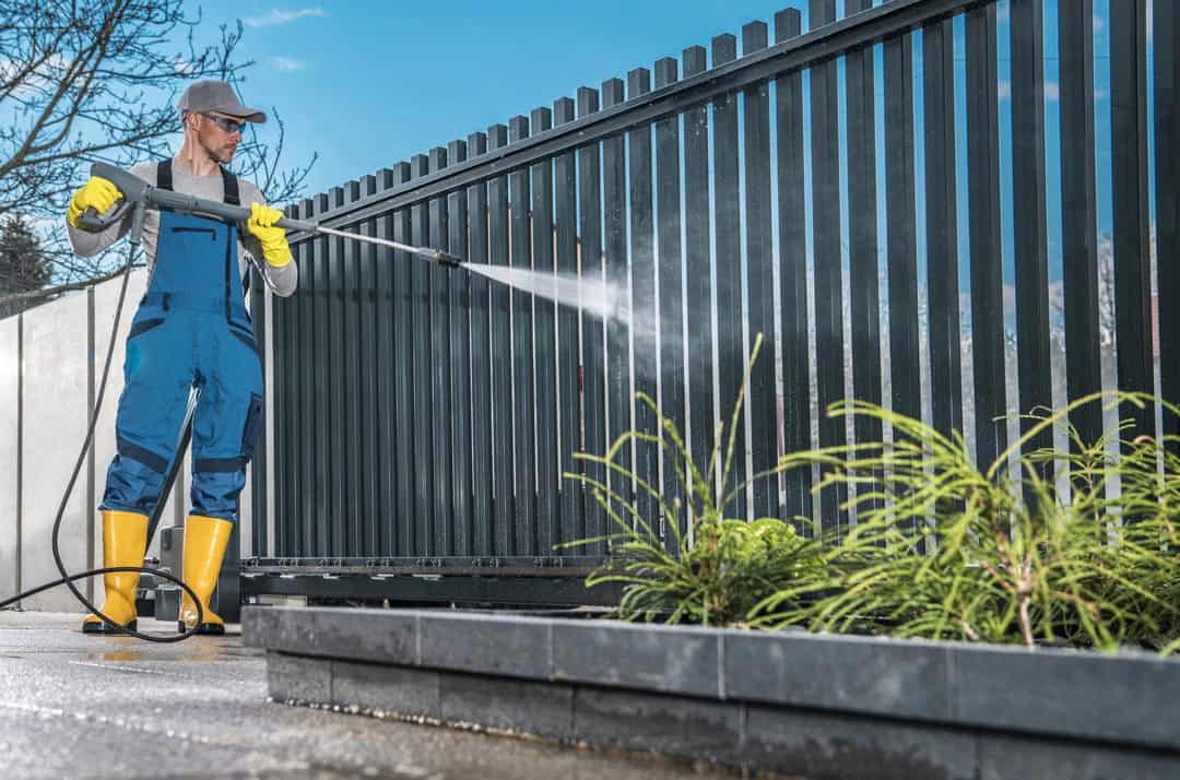 Caucasian Men Washing His Residential Driveway Gate